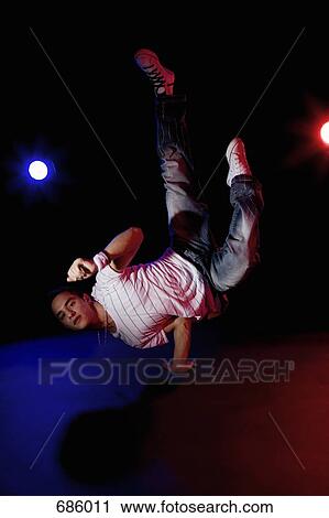 Stock Image - A B-boy doing a Pike Freeze breakdance move. Fotosearch