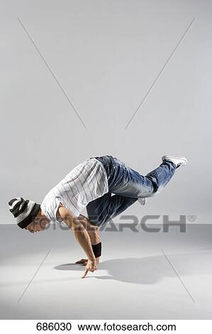 Stock Image - A B-boy doing an Airbaby breakdance move. Fotosearch