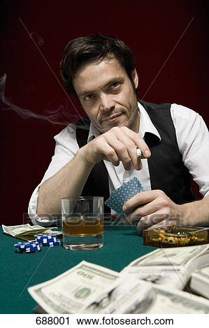 A man at a high stakes poker game looking suspicious View Large Photo Image Stock Image - A man at a high stakes poker game looking suspicious. Fotosearch