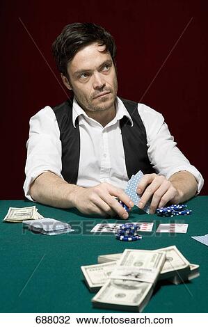 A man looking suspiciously at a high stakes poker game View Large Photo Image Stock Image - A man looking suspiciously at a high stakes poker game. Fotosearch
