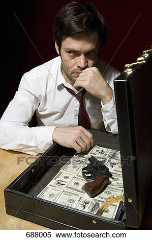 A man with a briefcase full of money and a handgun View Large Photo Image Stock Photography - A man with a briefcase full of money and a handgun. Fotosearch