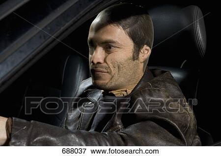 A man with a nylon over his face sitting in a car View Large Photo Image Stock Photo - A man with a nylon over his face sitting in a car. Fotosearch