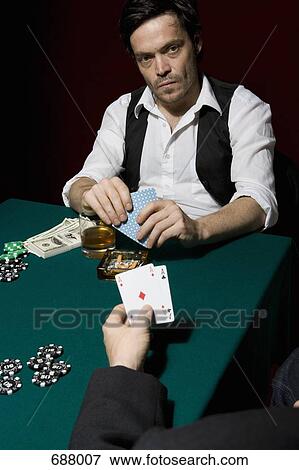 Two men playing poker at a high stakes game View Large Photo Image Stock Photo - Two men playing poker at a high stakes game. Fotosearch