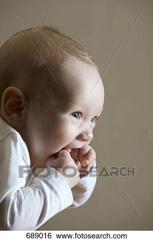 A baby boy sucking his hands View Large Photo Image Stock Photograph - A baby boy sucking his hands. Fotosearch