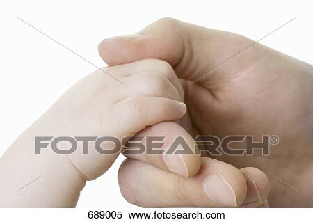 A baby's hand holding an adult's finger View Large Photo Image Stock Photography - A baby's hand holding an adult's finger. Fotosearch