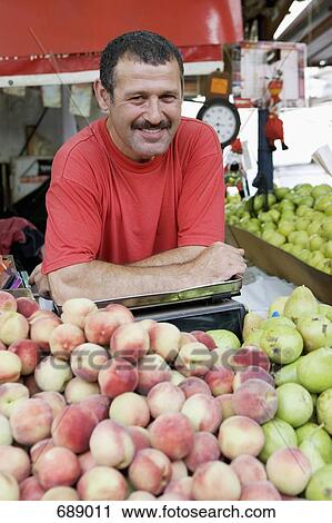 A man working on a fruit stall View Large Photo Image Stock Image - A man working on a fruit stall. Fotosearch