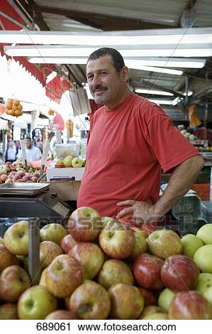 Stock Image - A man working on a fruit stall. Fotosearch