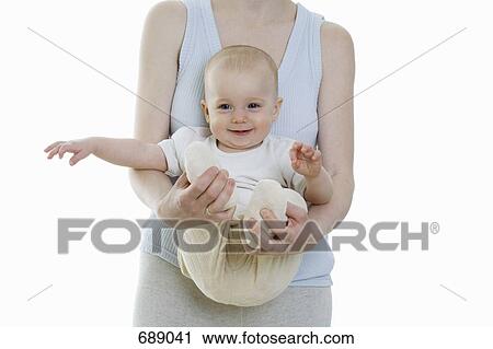 A mother holding a baby View Large Photo Image Stock Image - A mother holding a baby. Fotosearch