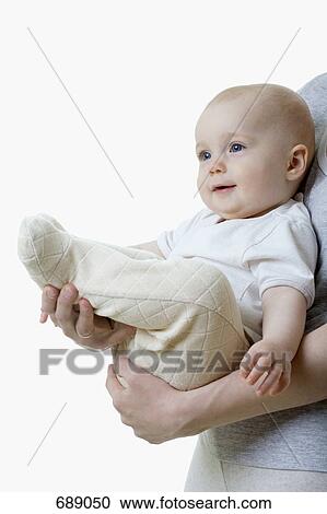 A mother holding a baby View Large Photo Image Stock Image - A mother holding a baby. Fotosearch