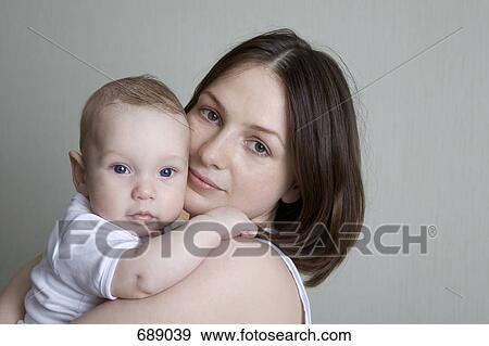 A mother holding a baby View Large Photo Image Stock Photo - A mother holding a baby. Fotosearch