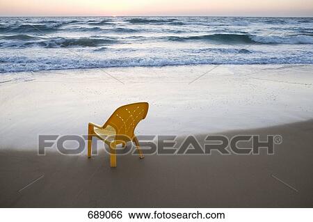 A plastic chair on the beach View Large Photo Image Stock Photograph - A plastic chair on the beach. Fotosearch