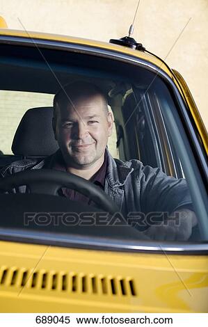 A taxi driver sitting in his car and smiling View Large Photo Image Stock Photography - A taxi driver sitting in his car and smiling. Fotosearch