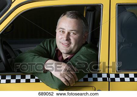 Stock Image - A taxi driver sitting in his car. Fotosearch