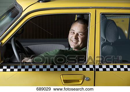A taxi driver sitting in his car View Large Photo Image Stock Photo - A taxi driver sitting in his car. Fotosearch