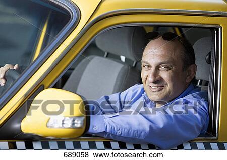 A taxi driver sitting in his car View Large Photo Image Stock Photo - A taxi driver sitting in his car. Fotosearch