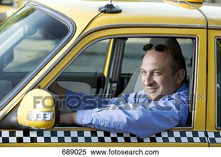 A taxi driver sitting in his car View Large Photo Image Stock Photography - A taxi driver sitting in his car. Fotosearch