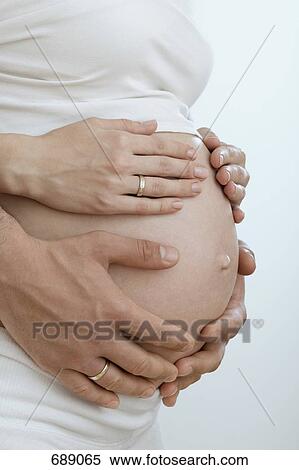 Husband holding pregnant wife's belly View Large Photo Image Stock Photography - Husband holding pregnant wife's belly. Fotosearch