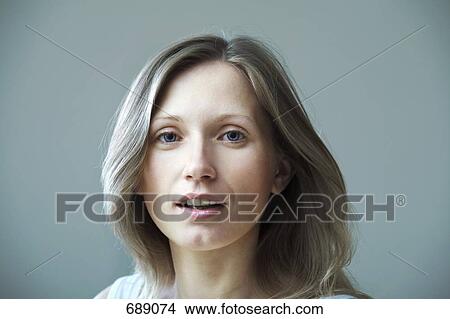 Portrait of a young woman with blond hair View Large Photo Image Picture - Portrait of a young woman with blond hair. Fotosearch