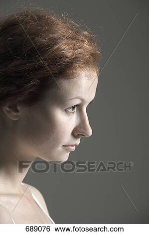 Portrait of a young woman with red hair View Large Photo Image Stock Photograph - Portrait of a young woman with red hair. Fotosearch