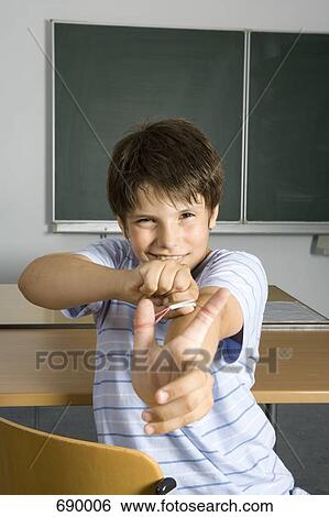 A pre-adolescent boy aiming a rubber band slingshot View Large Photo Image Stock Photograph - A pre-adolescent boy aiming a rubber band slingshot. Fotosearch