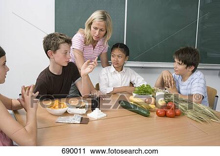 A teacher and four students learning about nutrition View Large Photo Image Stock Image - A teacher and four students learning about nutrition. Fotosearch