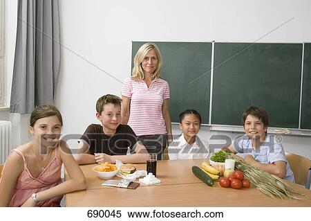 A teacher and four students learning about nutrition View Large Photo Image Stock Photography - A teacher and four students learning about nutrition. Fotosearch