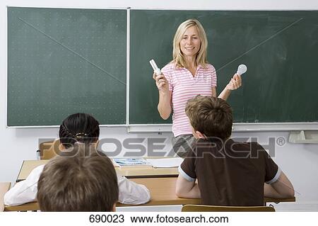 Teacher in front of her class View Large Photo Image Stock Image - Teacher in front of her class. Fotosearch