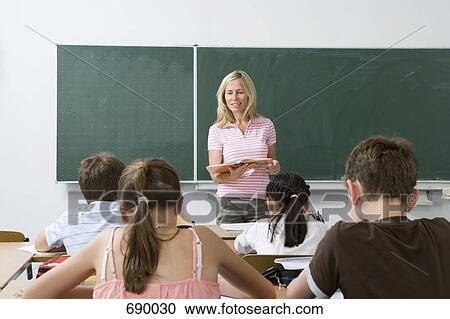 Stock Image - Teacher in front of her class. Fotosearch
