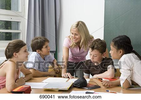 Stock Image - Teacher with her students. Fotosearch
