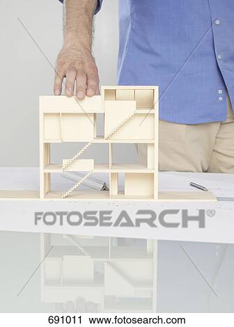 Stock Image - A man looking at an architectural model. Fotosearch