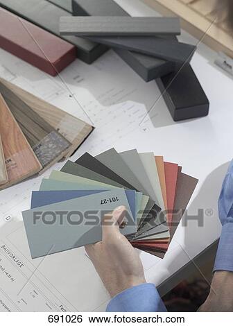 A person comparing color swatches View Large Photo Image Stock Photograph - A person comparing color swatches. Fotosearch