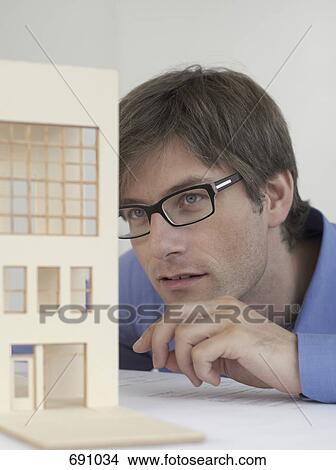An architect examining an architectural model View Large Photo Image Picture - An architect examining an architectural model. Fotosearch