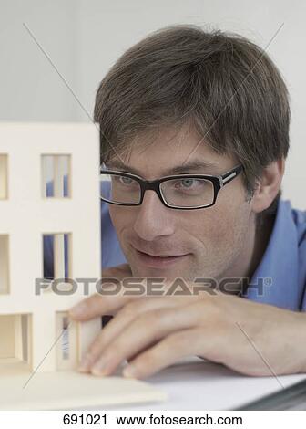 An architect examining an architectural model View Large Photo Image Stock Image - An architect examining an architectural model. Fotosearch