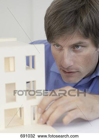 An architect examining an architectural model View Large Photo Image Stock Image - An architect examining an architectural model. Fotosearch