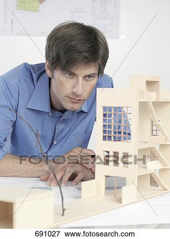 An architect examining an architectural model View Large Photo Image Stock Photo - An architect examining an architectural model. Fotosearch