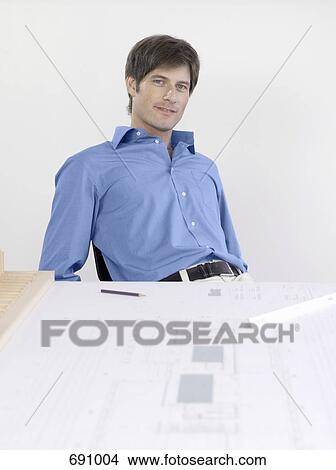 An architect sitting at his desk View Large Photo Image Picture - An architect sitting at his desk. Fotosearch