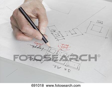 An architect sketching a plan View Large Photo Image Stock Photo - An architect sketching a plan. Fotosearch