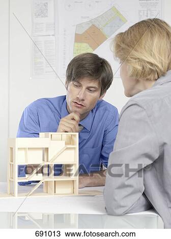 Two people discussing an architectural model View Large Photo Image Stock Image - Two people discussing an architectural model. Fotosearch
