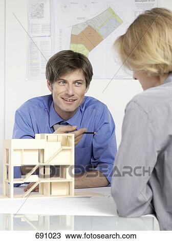 Two people discussing an architectural model View Large Photo Image Stock Image - Two people discussing an architectural model. Fotosearch