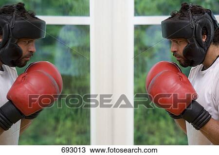 Stock Image - A boxer staring at his reflection. Fotosearch
