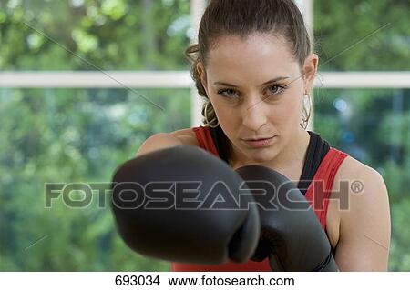 A female boxer punching, front view View Large Photo Image Picture - A female boxer punching, front view. Fotosearch