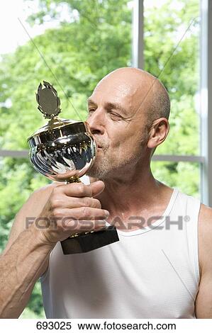 A man kissing a trophy View Large Photo Image Stock Photography - A man kissing a trophy. Fotosearch