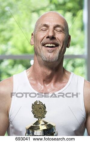 A man with a trophy for gymnastics View Large Photo Image Stock Image - A man with a trophy for gymnastics. Fotosearch