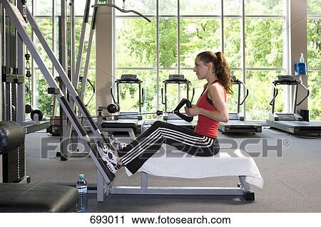 A woman using a weight machine View Large Photo Image Stock Image - A woman using a weight machine. Fotosearch