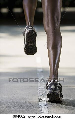 A woman jogging, rear view View Large Photo Image Stock Image - A woman jogging, rear view. Fotosearch