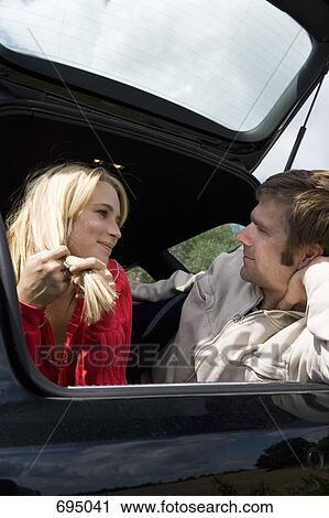 A couple lying together in the back of a car View Large Photo Image Stock Image - A couple lying together in the back of a car. Fotosearch