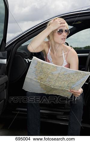 A woman reading a roadmap and looking confused View Large Photo Image Picture - A woman reading a roadmap and looking confused. Fotosearch