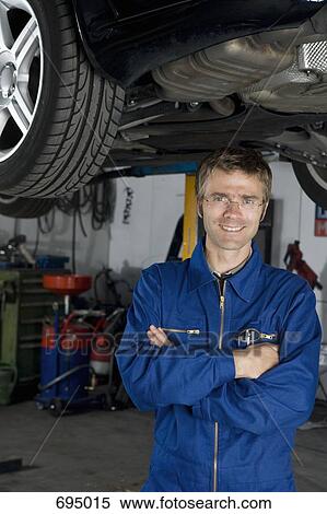 Portrait of a mechanic in a repair garage View Large Photo Image Stock Photography - Portrait of a mechanic in a repair garage. Fotosearch