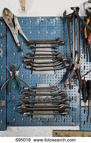 Stock Photo - Tools hanging on a workshop wall. Fotosearch