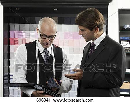A choosing a fabric with a tailor View Large Photo Image Stock Image - A choosing a fabric with a tailor. Fotosearch